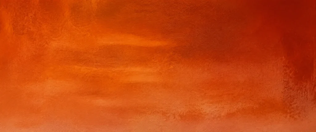 Gros plan sur les nuances et la matière de l’œuvre Terre rouge